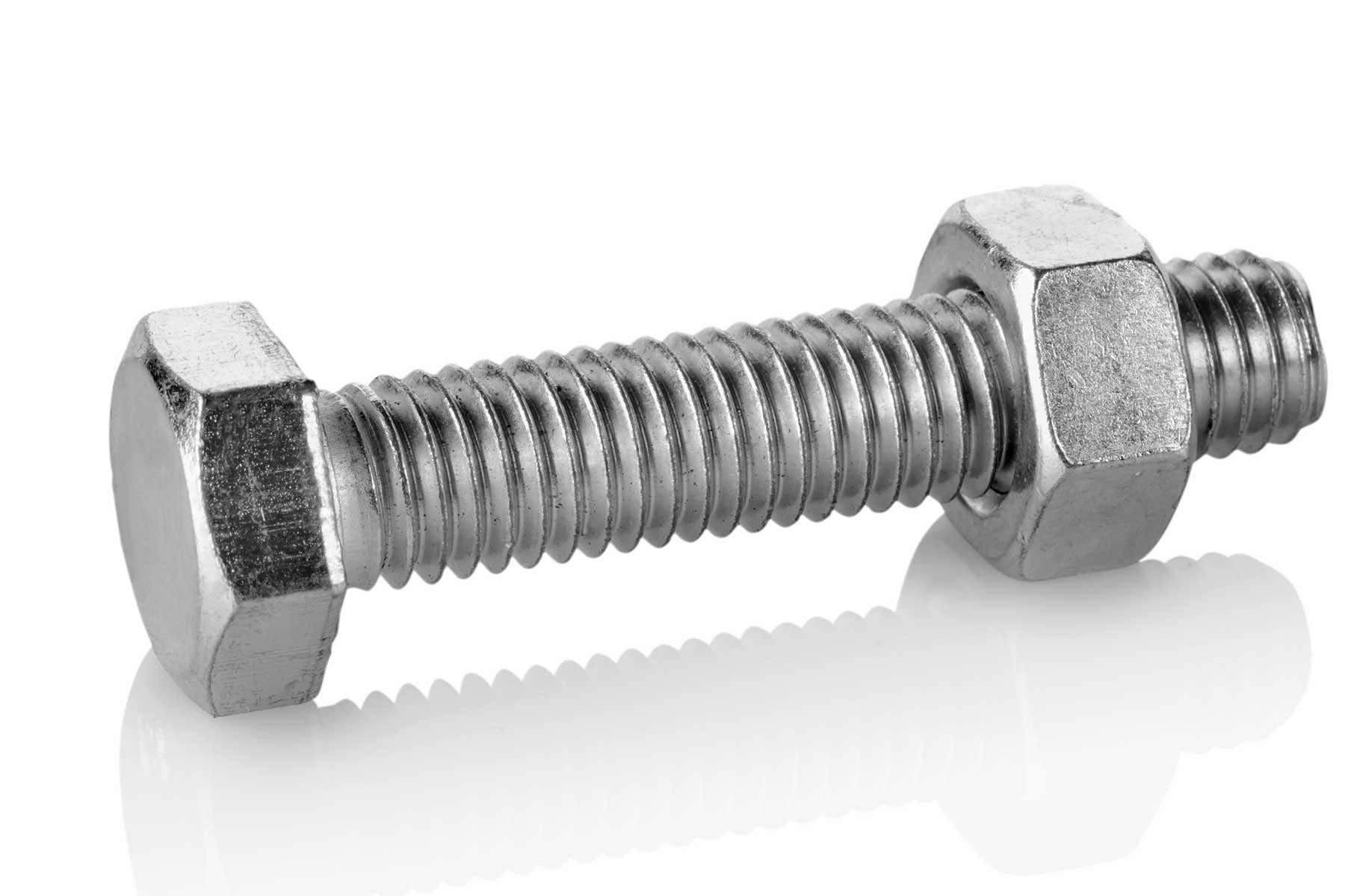 "Various types of stainless steel nuts and bolts arranged by size on a wooden background"